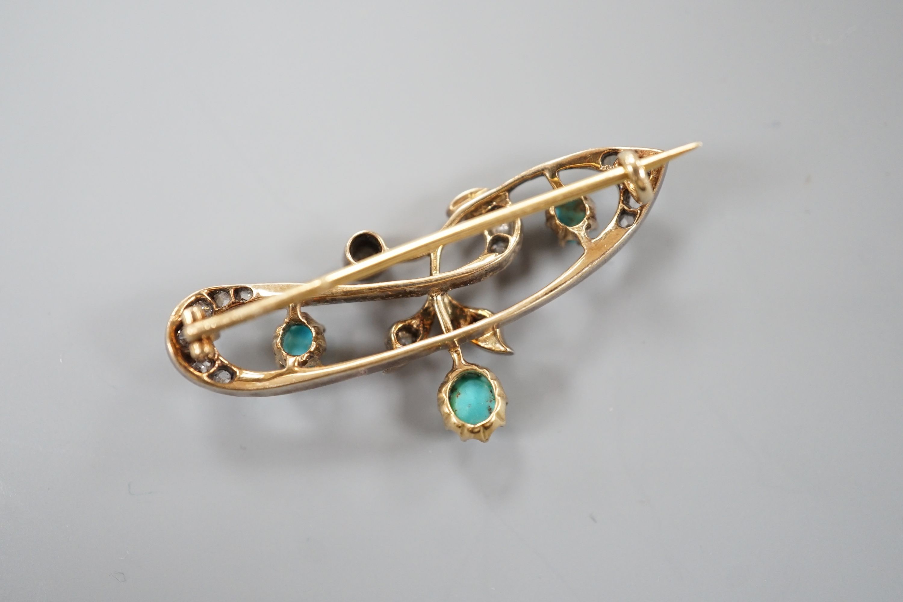 A late Victorian yellow metal, turquoise and diamond set openwork scroll brooch, 40mm, gross weight 5.5 grams.